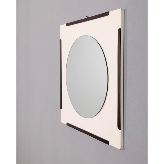 Wall mirror with white lacquered wooden frame and dark wood inserts, designed by Fratelli Sbrilli, 1970s This piece has an...