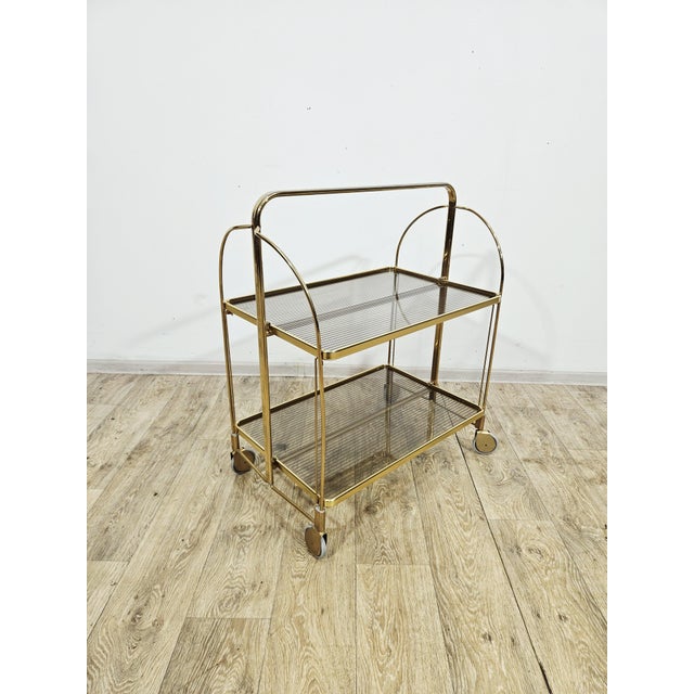 For sale: an exceptionally elegant and rare folding bar cart (serving trolley) from the 1960s. This piece epitomizes the...