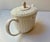 This is a Wedgwood Nantucket series teapot in fine bone china. It features an embossed basketweave pattern design and a...