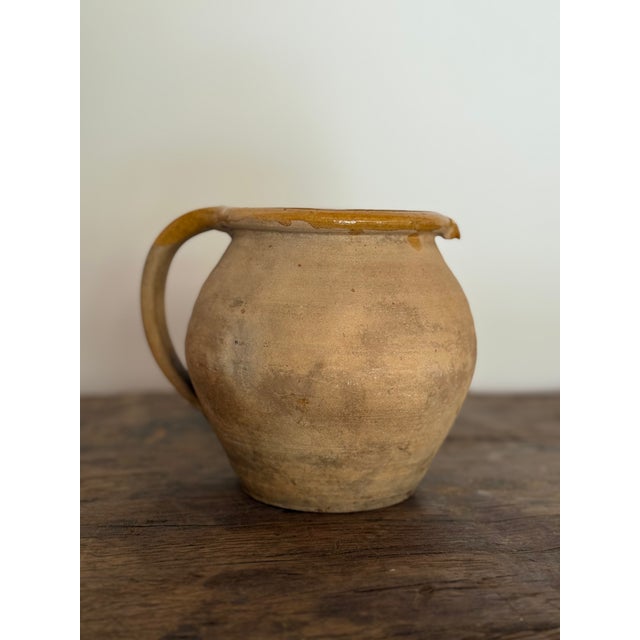 An antique French stoneware jug from the 19th century, hand-thrown in the tradition of everyday French farmhouse pottery....