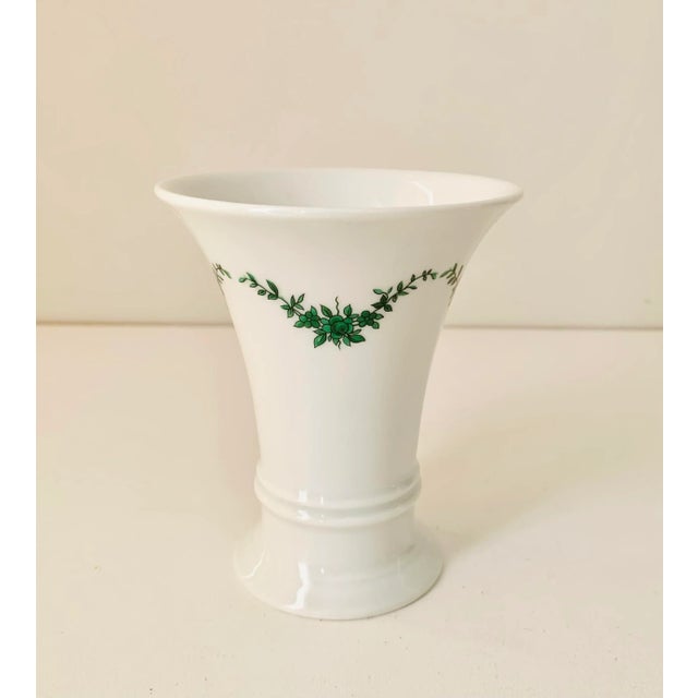 What a lovely small porcelain vase made by Furstenberg Germany! Decorated with a beautiful a green wreath design, this...