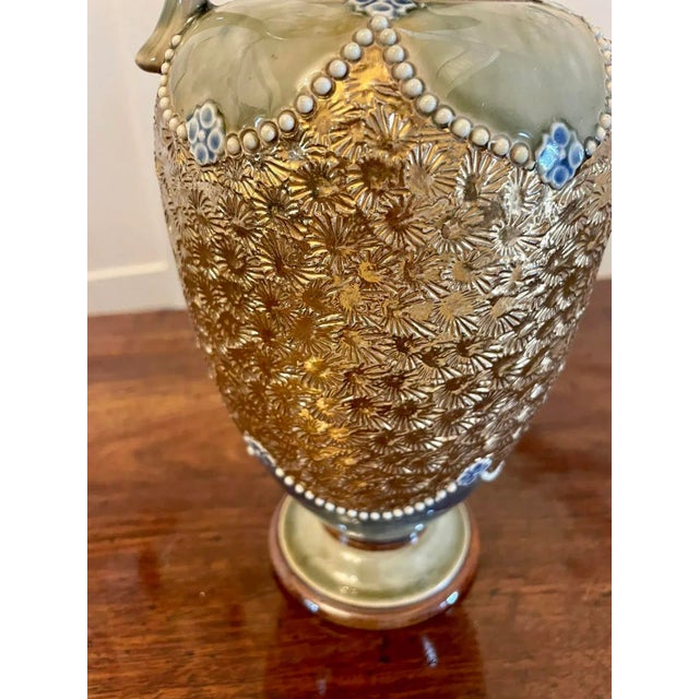 Antique Victorian quality Doulton Lambeth jug having a quality Doulton Lambeth jug with a shaped handle and neck in...