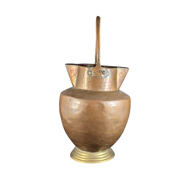 Likely from the middle of the 19th century, this copper pitcher measures about 10.5 inches from bottom to spout, 15 inches...