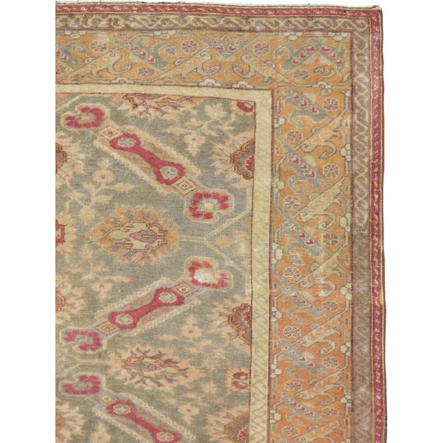 A vintage Turkish Sivas rug from the mid-20th century. This eastern Turkish city rug mixes the St. Andrew’s cross design...