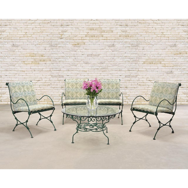 A charming mid-century French Provincial garden or patio table crafted out of wrought iron and glass by O. W. Lee,...