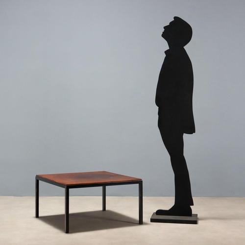 Coffee table with enamelled metal base and square top with exotic wood veneer. This piece is attributed to the mentioned...