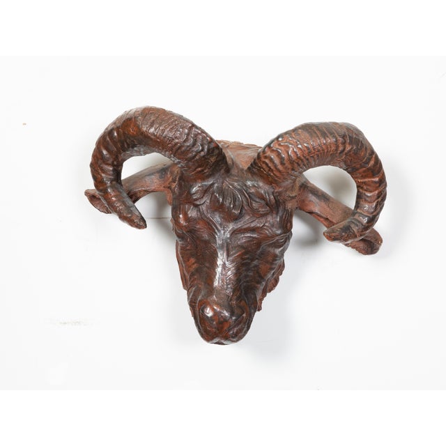 An Italian wall hanging patinated iron ram's head sculpture from the 19th century, with rusty finish and great finesse in...