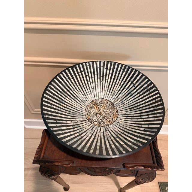Striking oversized decorative bowl crafted from black-finished wood and inlaid with natural mother of pearl in a dramatic...