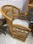 A charming vintage Brighton Pavilion-style rattan dining set featuring a round glass-top table and four coordinating...