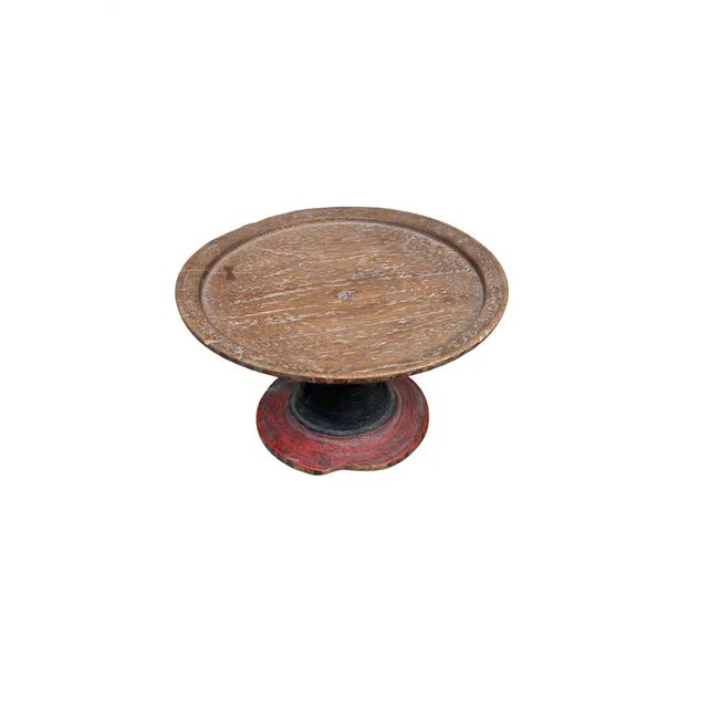 An antique Balinese dulang offering tray featuring a deep red lacquer finish softened by time. The surface shows gentle...