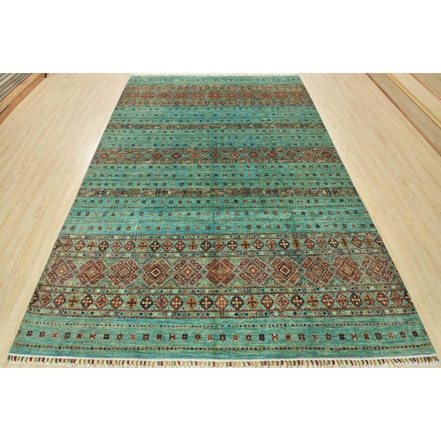 This tribal Khorjin rug is hand-knotted with an all-wool pile on a cotton foundation. This beautiful oriental rug features...