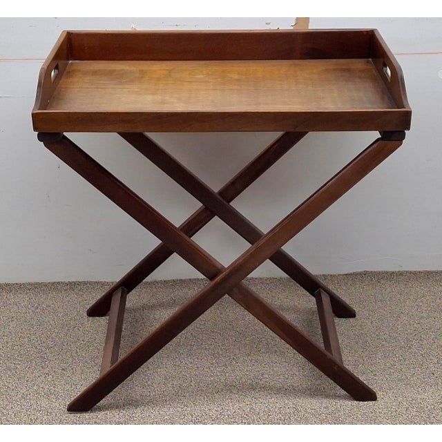 English Regency walnut butler's tray table with a removable top and folding stand. The tray features pierced handles for...