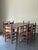 Incredible antique dining set with painted wood table and painted ladder back chairs with catgut seats. The set includes a...