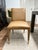 Perfect for modern dining, this armless chair features sleek lines covered in a rich camel faux leather accented with...