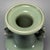 This handmade Longquan celadon vase is fitted with a pair of carved dragon‑form side handles. Smooth glaze covers the...