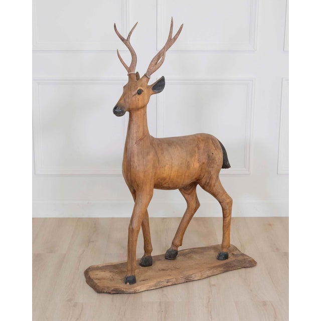 A striking Italian 20th century life-size deer sculpture, expertly hand-carved in solid walnut with a wonderfully...