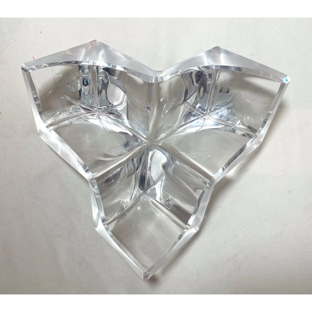 This heavy sculptural French crystal vide poche was made by Daum and has an angular form executed in clear and frosted...
