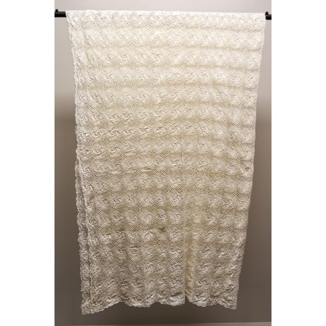 A beautifully handcrafted vintage crochet tablecloth featuring an intricate swirling floral motif. Its delicate openwork...