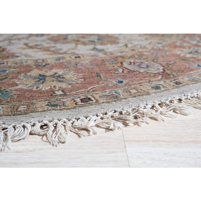 This hand knotted pile rug features a primary color palette of ivory, beige, cream, and white. Crafted from wool, this...
