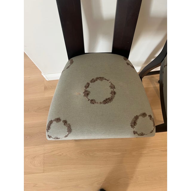 An exquisite pair of ebonized bar stools from Angelo Donghia featuring metal foot protectors, rectangular backs with an...