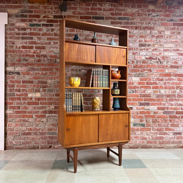 Vintage mid-century modern teak and Afromosia room divider bookcase in the manner of OFM Belgium, c.1960s-70s. This...