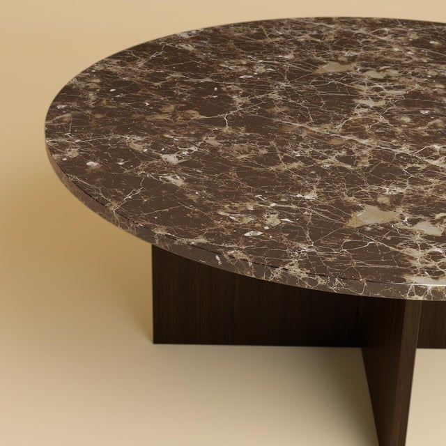 Emperador Dark marble over a base of solid oak gives the Hirado its balance. It is a low table for the space in front of a...