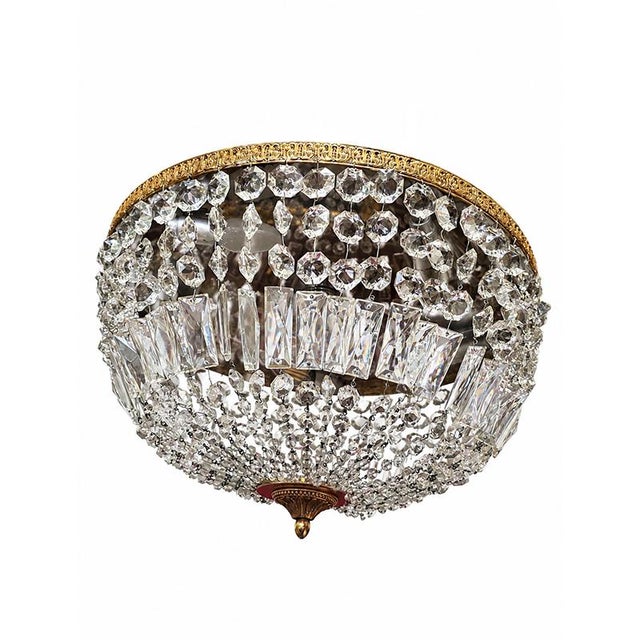 An elegant Empire-style ceiling light, featuring a refined circular structure in gilded bronze embellished with a rich...