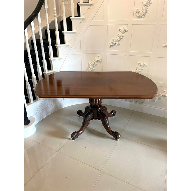 Antique Victorian quality mahogany dining table having a quality mahogany tilt top with shaped ends and a moulded edge...