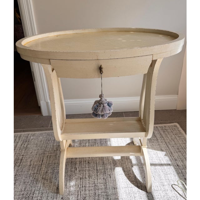 Pair of creamy colored side tables in Gustsvian, neoclassical style with single drawer and lovely detailed profile.
