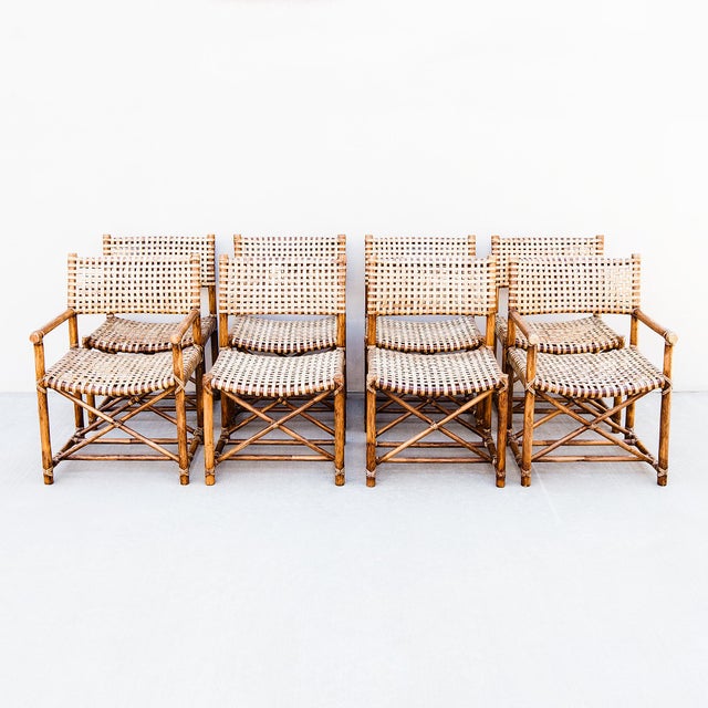 A rare set of eight vintage bamboo and woven leather "Antalya" dining chairs by McGuire, produced in the late 1980s. The...