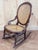 A beautifully detailed vintage Victorian-style rocking chair crafted in mahogany, combining decorative carving with the...