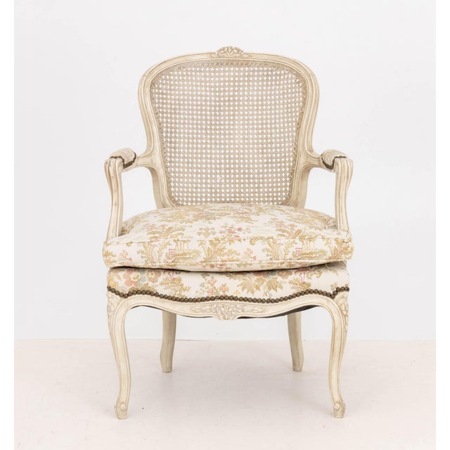 Louis XV Style Cane Paneled Back Fauteuil, the upholstered seat with Chinoiserie style pattern, the frame white painted...