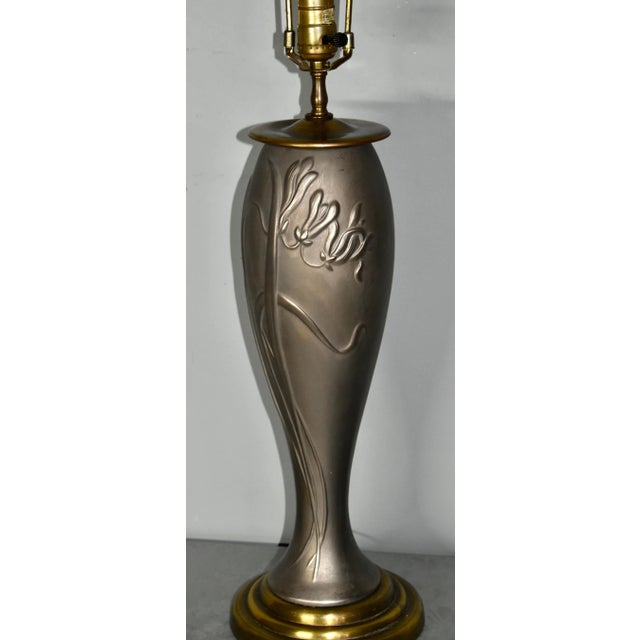 Vintage (1980's) Table Lamp has an Art Nouveau Style. Made of Metal & Brass with Floral details. The Measurements: 7"W x...