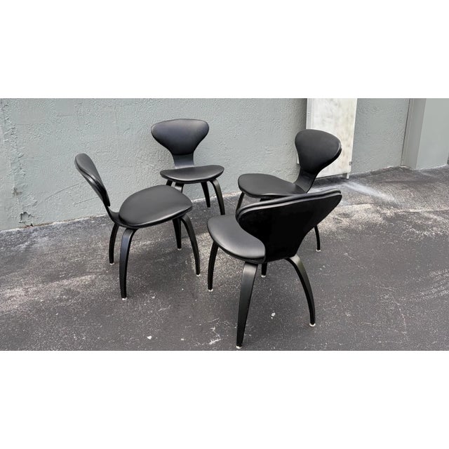 A set of 4 black, vintage Mid-Century Modern American Pretzel dining room side chairs designedby Norman Cherner and...
