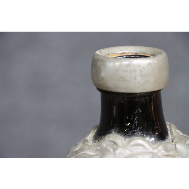 Danish glass flask featuring a deep emerald green glass body with an ornate, raised pewter overlay in a scrolling foliate...
