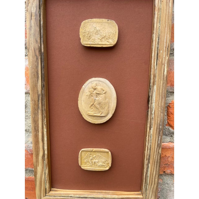 Immerse yourself in the enduring allure of classical antiquity with this truly unique collection of framed intaglios....