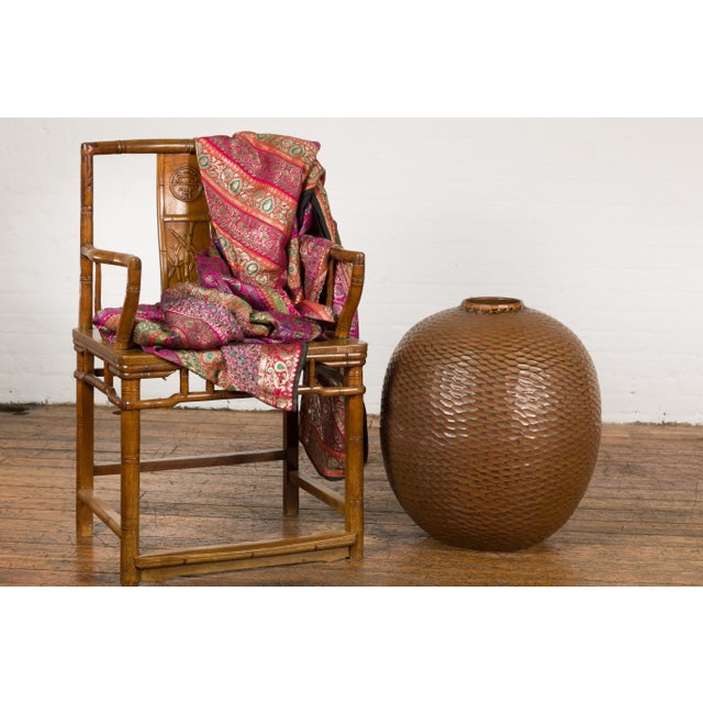 A contemporary Prem Collection artisan handcrafted ceramic vase with brown textured finish, round shape, honeycomb style...