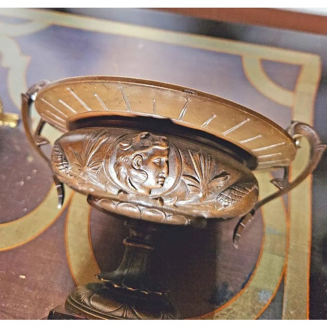 Pair of cups, Tazza, ancient, in patinated bronze, representing the profile of Heracles carrying the lens and opposite an...