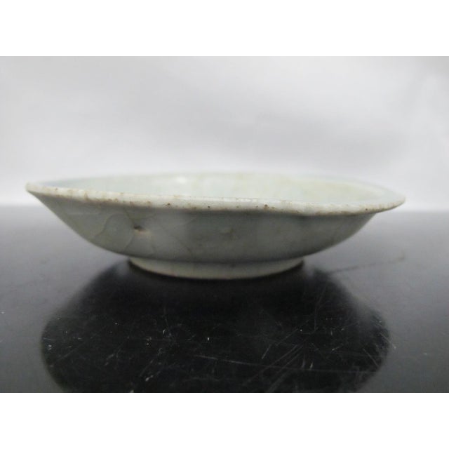 Chinese Ming Dynasty saucer dish. Blue porcelain plate showing abstract centralized design. Possibly a fish or foo dog...