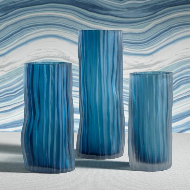 This blue vase will enhance your home with a perfect mix of form and function. Depicting an image of murky waters, the...