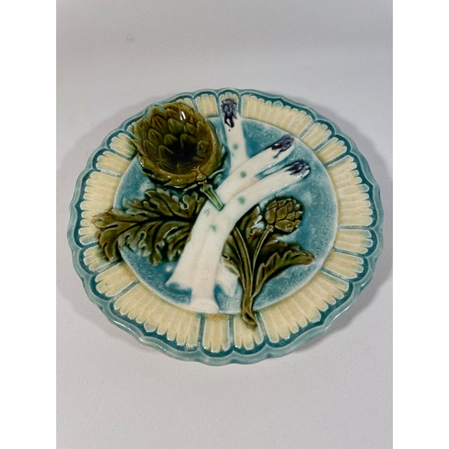 A charming ceramic French Majolica Asparagus Plate with a decorative artichoke sauce compartment. Circa 1880-1890s. Made...