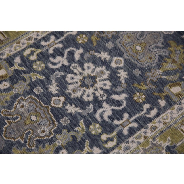 This modern Turkish Oushak rug is a stunning piece of art that has been handwoven using traditional techniques by skilled...