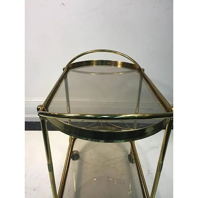 A sensational, Italian, brass, two-tier bar or tea cart with unusual oval shape, circa 1960.