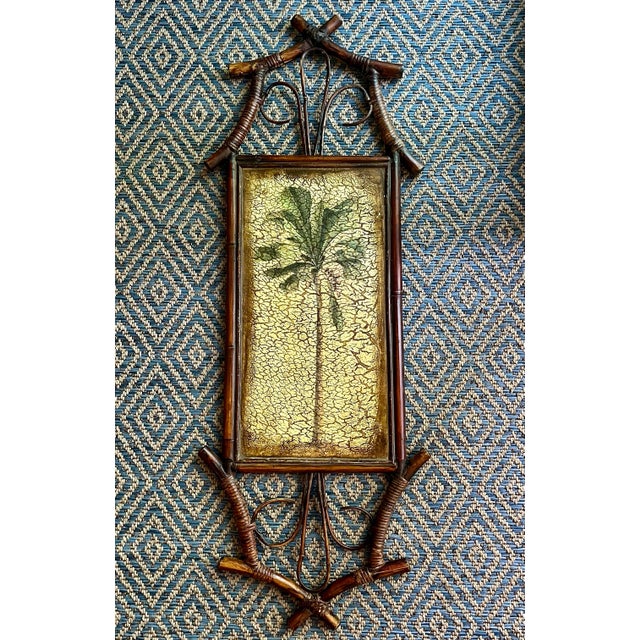 Vintage 1990s palm tree wall art print with faux crackle finish in a real bamboo frame. Features hanging brackets on the...