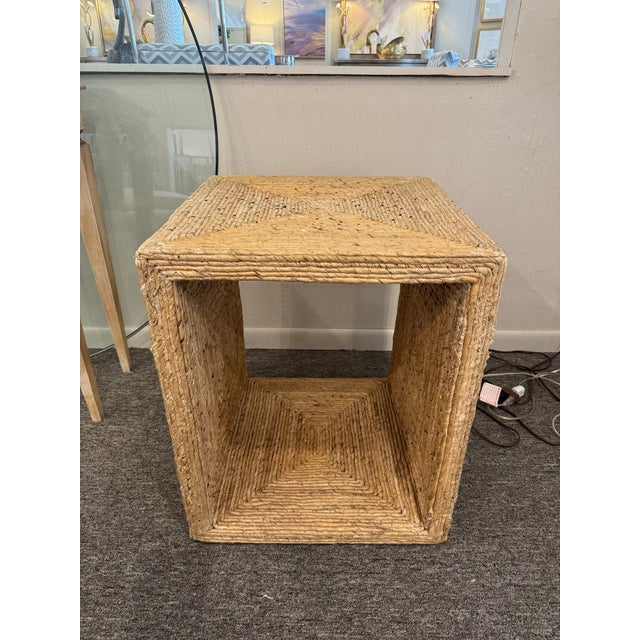 This square rattan end table brings natural texture and casual charm to any space. Designed with an open base for airy,...