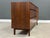 A mid century modern walnut sideboard credenza or dresser with pull out vanity drawer designed by Kipp Stewart for...