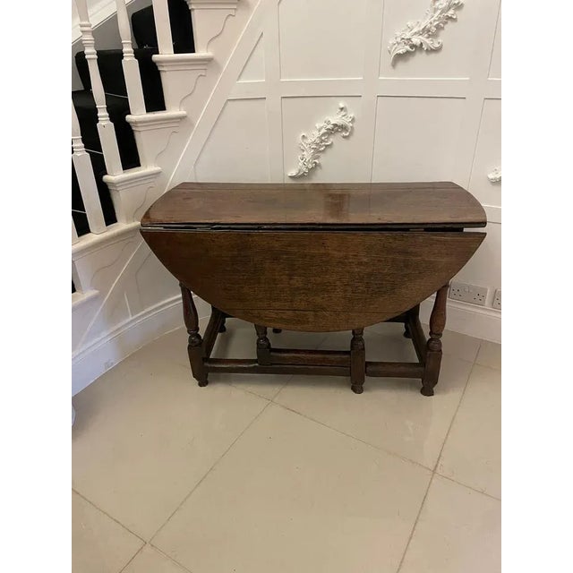 18th century antique quality oak drop leaf dining table having a quality oak top with 2 oval drop leaves supported by 2...