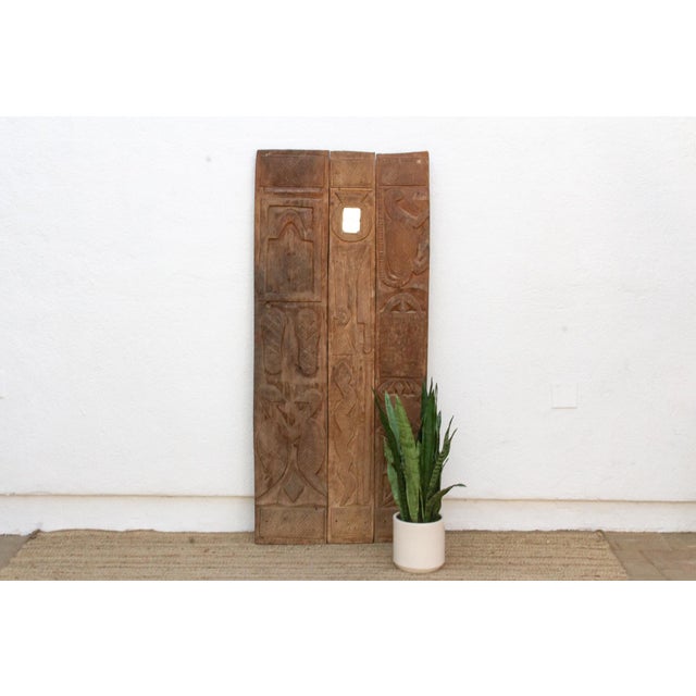Attributed to the early-to-mid 20th century (circa 1920s–1950s), this 65-inch architectural entrance door is a three-plank...