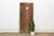 Attributed to the early-to-mid 20th century (circa 1920s–1950s), this 65-inch architectural entrance door is a three-plank...