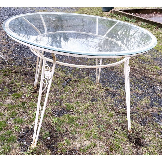 This is a wonderful quality round glass top table with rose and vine decoration on all four legs. The shape of the legs...